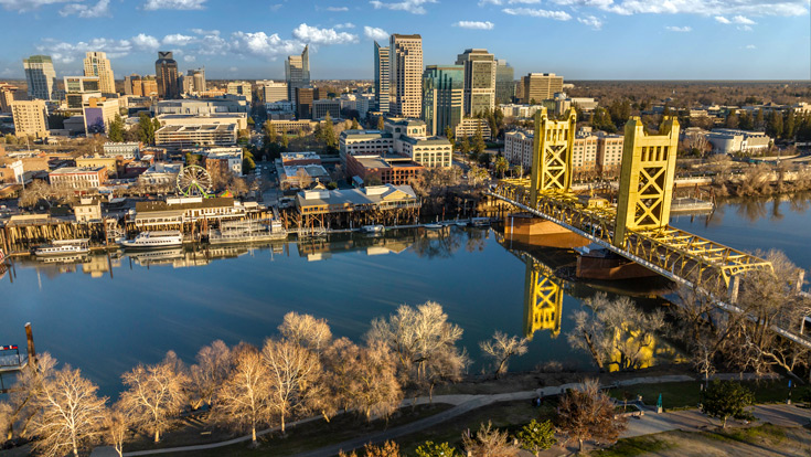 Aerial photo of Sacramento river, skyline, and Tower Bridge on a sunny day