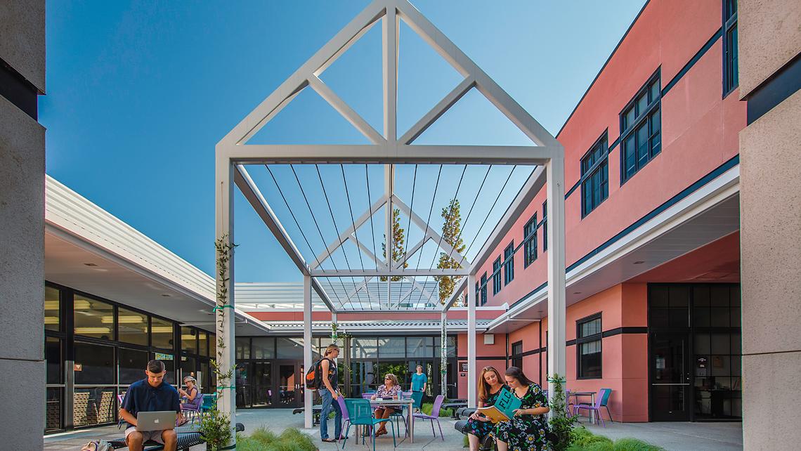 Students hanging out in an exterior lounge area